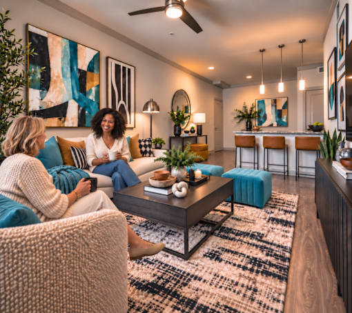 Two women sitting on a couch in a living room.