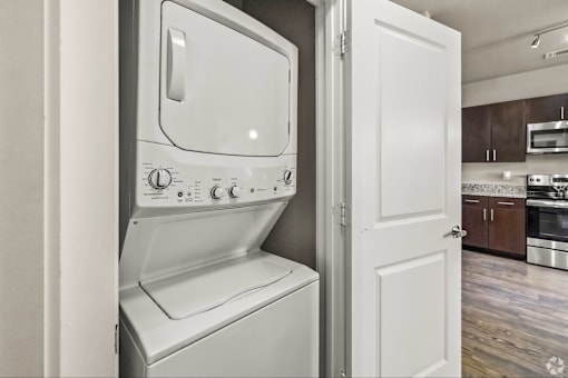 A white oven with a microwave built in is in a kitchen.