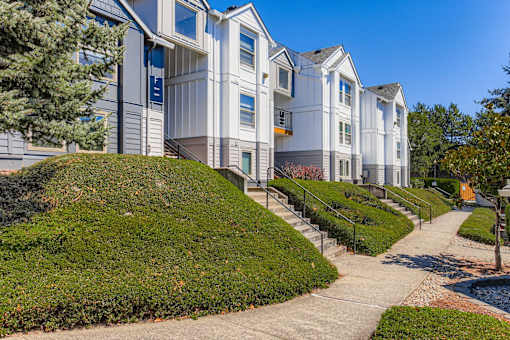 A white building with a green lawn in front.