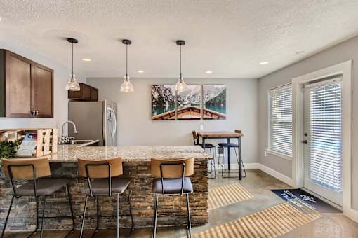 Apartments Near Happy Valley For Rent - Sunnyside Village - Clubhouse With Seating Area and Island Table