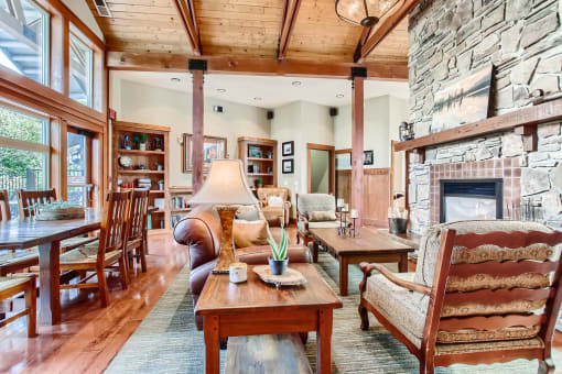 One-Bedroom Apartments in Fairview, OR - Lodges at Lake Salish - Clubhouse with Comfortable Seating, Oversized Windows, and a Fireplace