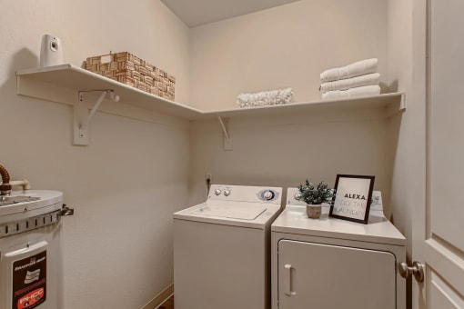 Fairview, OR Apartments for Rent - Laundry Room with Shelving and In-Unit Washer and Dryer.