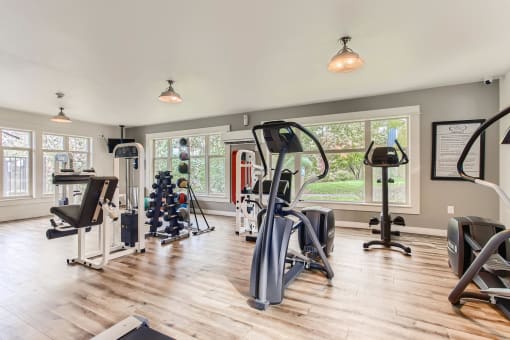 Fairview OR Apartments - Lodges at Lake Salish - Resident Fitness Center WIth Ellipticals, Handweights, and Various Other Exercise Machines and Equipment