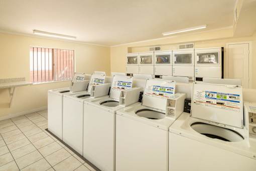 A row of washing machines in a laundromat.