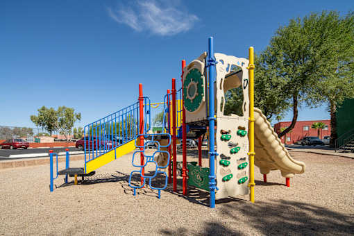 A playground with a slide, swings, and climbing structures.