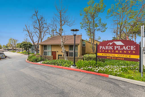 A sign for Park Place Apartments is in front of a building.