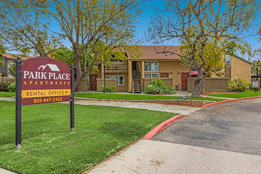 A sign for Park Place Apartments is in front of a building.