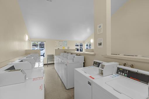 A laundry room with washers and dryers.