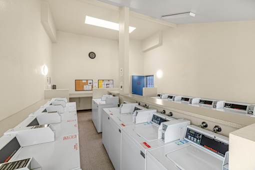 A laundry room with washers and dryers.