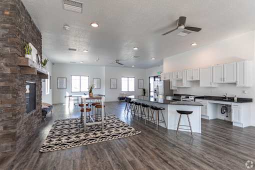A modern kitchen with a dining area and a fireplace.