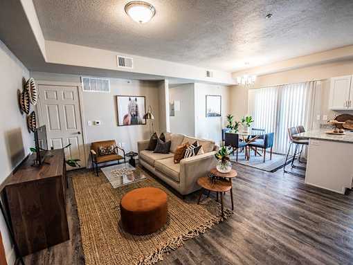 A living room with a couch, chairs, and a coffee table.
