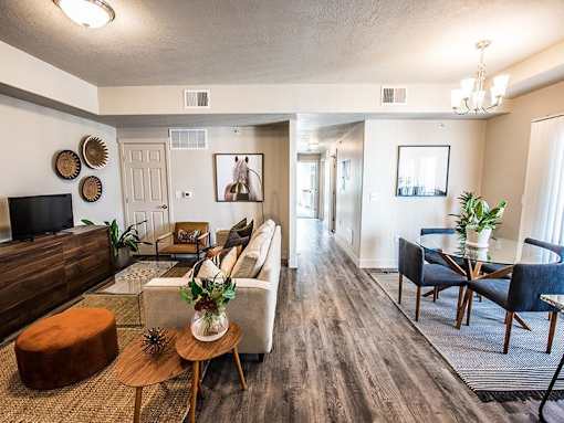 A living room with a brown wooden floor and furniture.