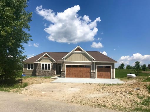 a house with a garage and a gravel driveway