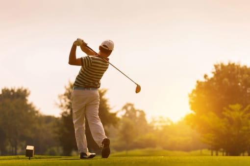 a man swinging a golf club on a golf course