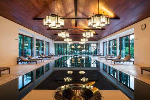 a large pool with a large chandelier hanging from the ceiling
