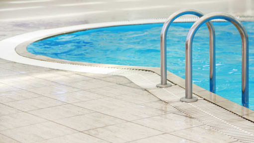 a swimming pool with a metal fence next to it