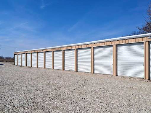 A long row of closed grey storage units with wooden supports.
