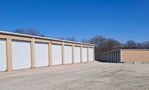 A series of storage units with closed doors are lined up in a row.