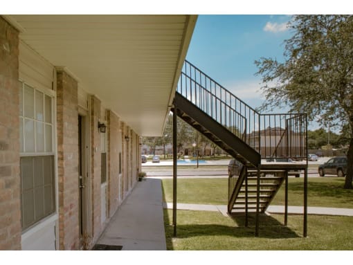 an exterior view of a building with a staircase leading up to the second floor of the building