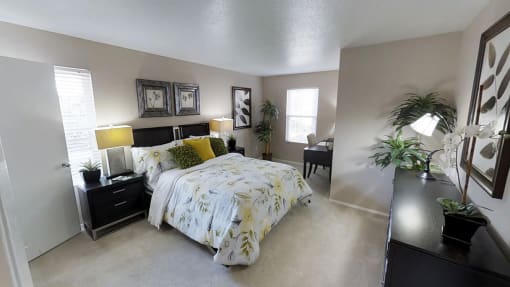 a bedroom with gray walls and a yellow and green bedspread