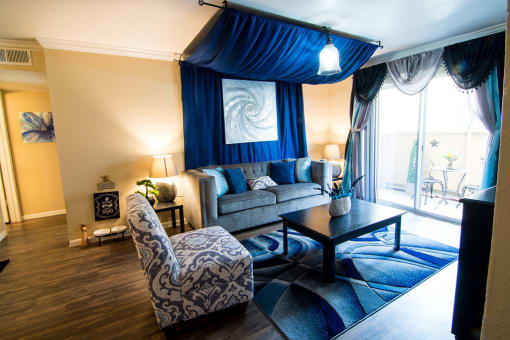 a living room filled with furniture and a large window