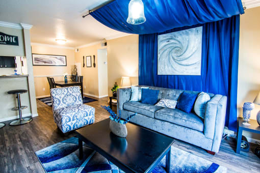 a living room with a couch and chair and a coffee table