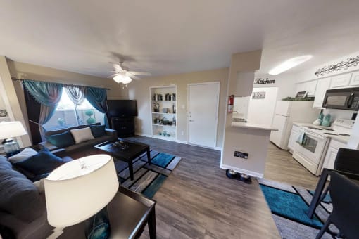 an open concept living room with a kitchen and dining area