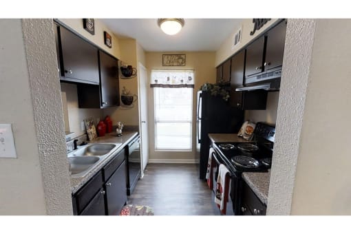 a kitchen with a stove a sink and a refrigerator