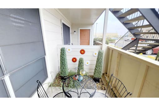 a small patio with a table and chairs