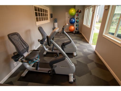a room with two treadmills and an exercise ball