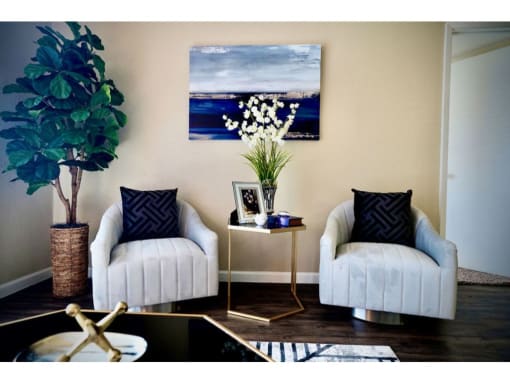 a living room with two chairs and a table