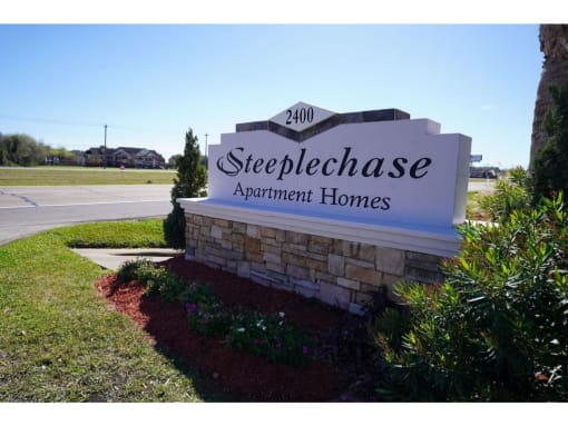 a sign at the entrance of steppe chase apartment homes