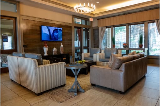 a living room filled with furniture and a flat screen tv