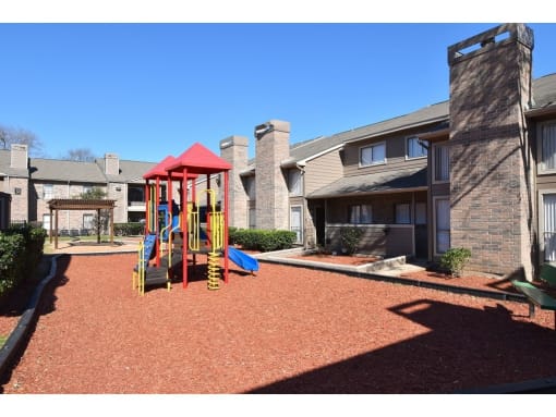 this is a photo of the playground at harvard heights apartments in dallas, tx