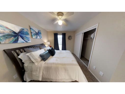 a bedroom with a bed and a ceiling fan