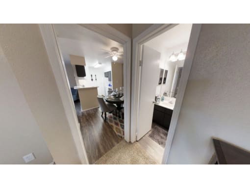 a room with a table and chairs and a ceiling fan