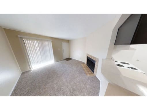 a living room with a fireplace and a window