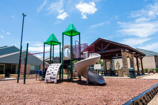 a playground with a slide and a clock