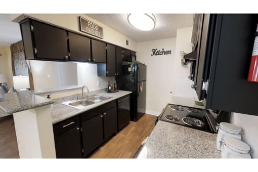 a kitchen with a stove top oven next to a sink