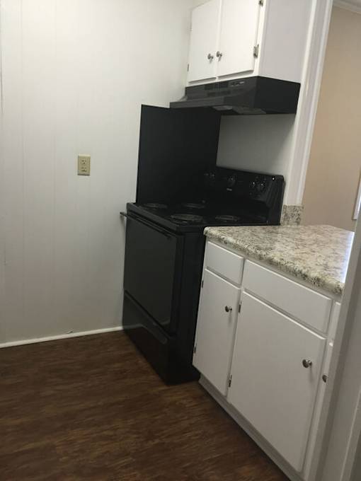 A black oven and stove top are on a kitchen island.