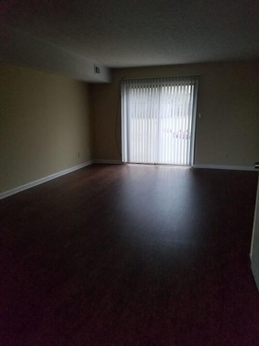A room with a sliding door and a window.