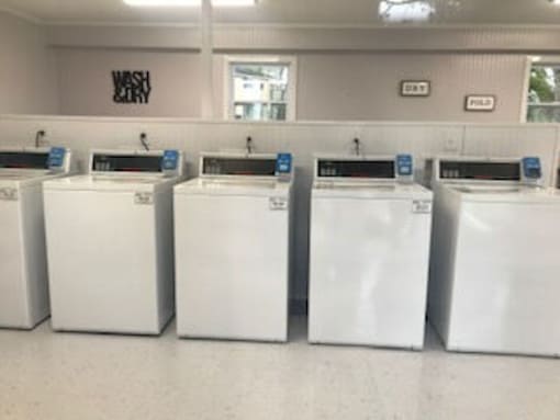 A row of washing machines in a laundromat.