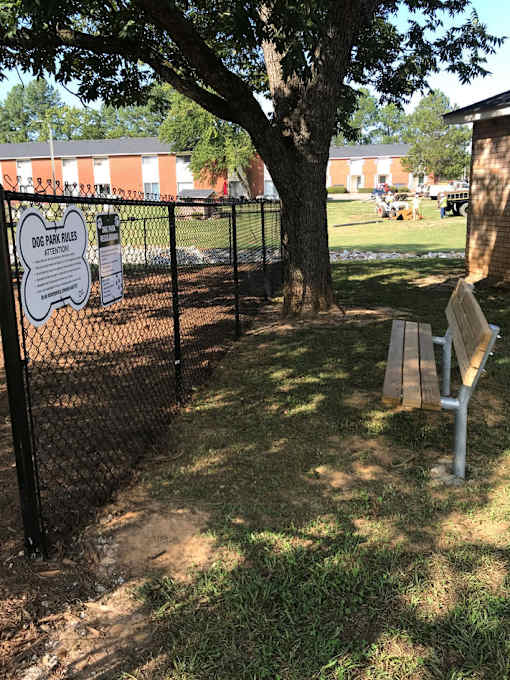 A sign on a fence reads "Woodlawn Cemetery".