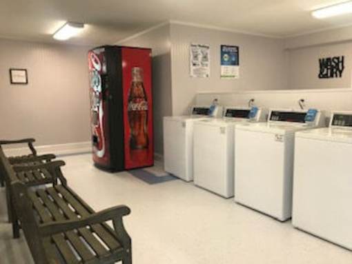 A row of washing machines in a laundromat.