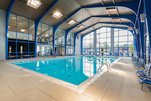 A large indoor swimming pool with a sunken seating area.
