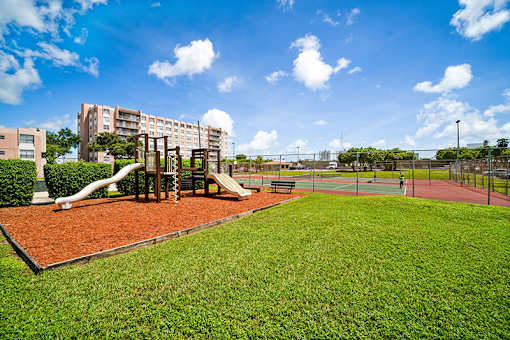 A playground with a slide and a basketball court.