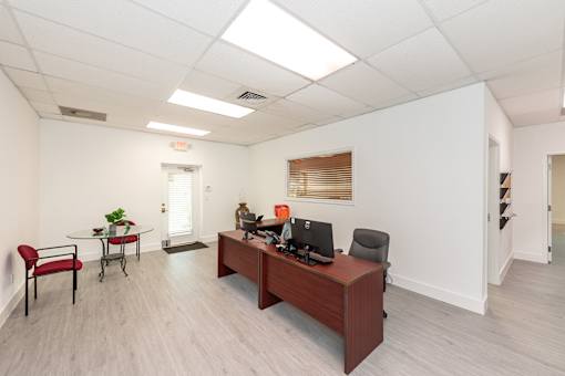 A room with a desk and a chair.