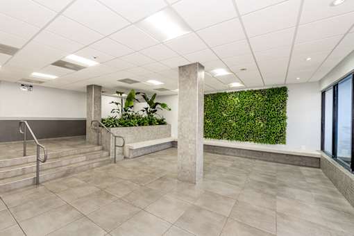 A green wall in a white room with a staircase.