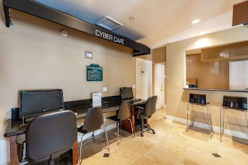 A room with a sign that says Cyber Cafe.
