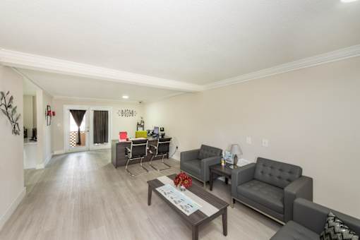 A living room with grey couches and a wooden coffee table.